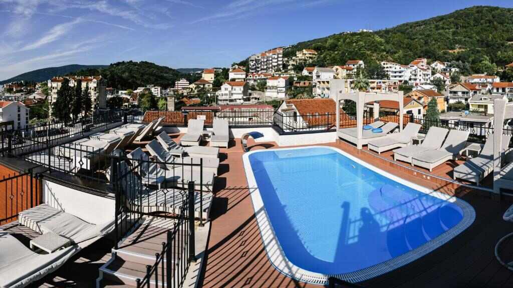 Rooftop swimming pool with sun loungers
