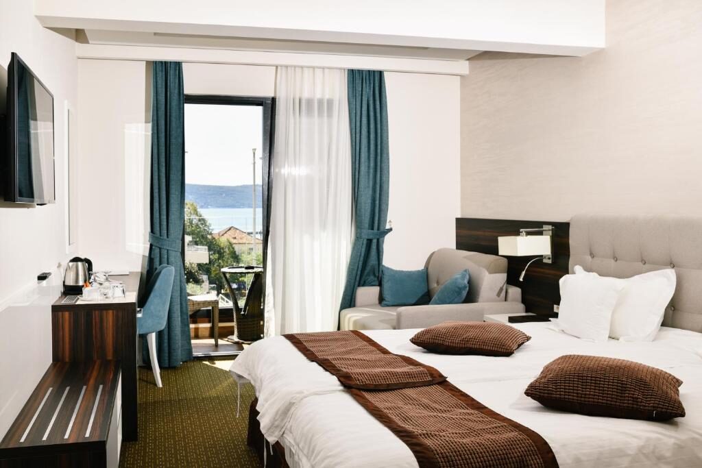 Bright hotel room with sea view and seating area